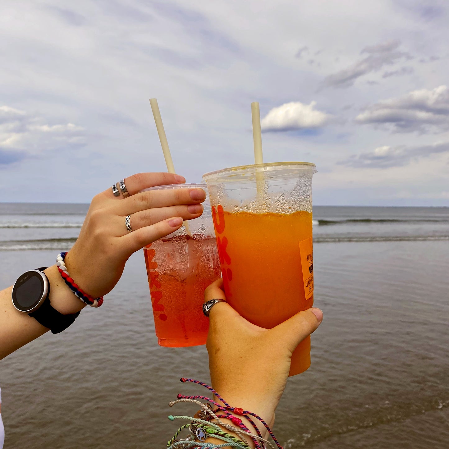 Home compostable drinking straws in iced drinks by the ocean