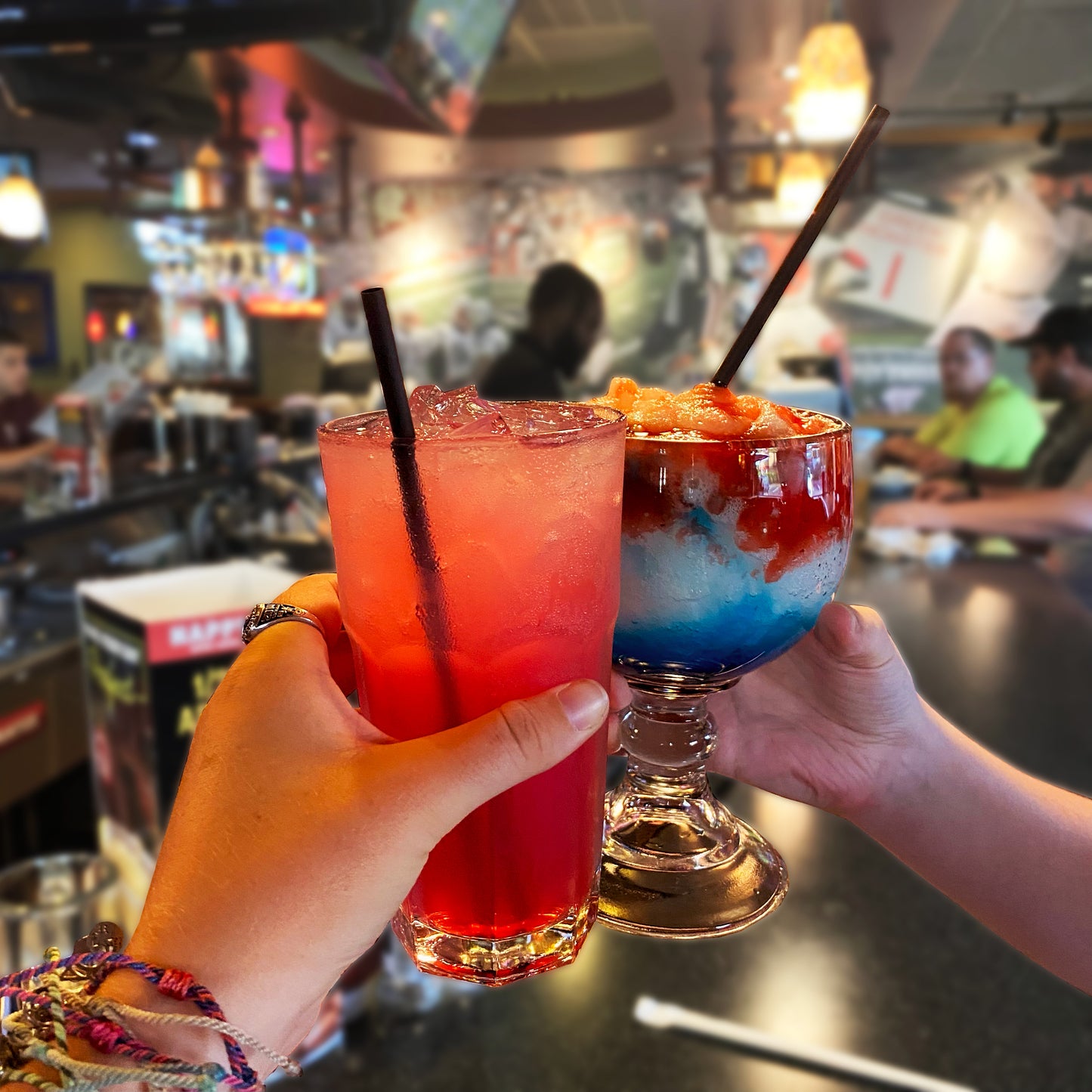 Black compostable drinking straws in cocktails at bar