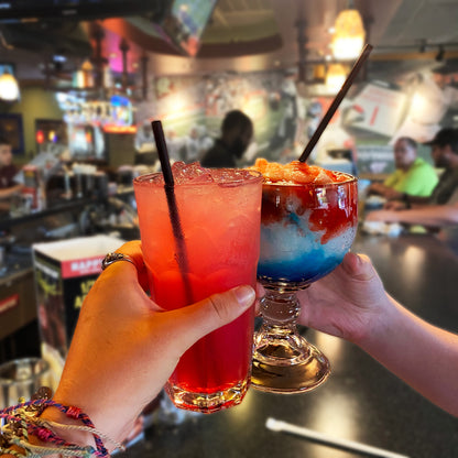 Black compostable drinking straws in cocktails at bar

